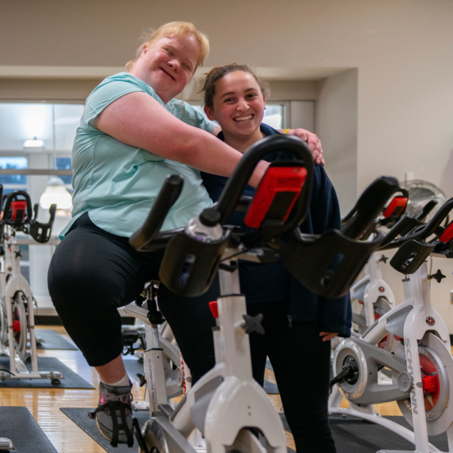 Girl smiling in an adaptive cycling class