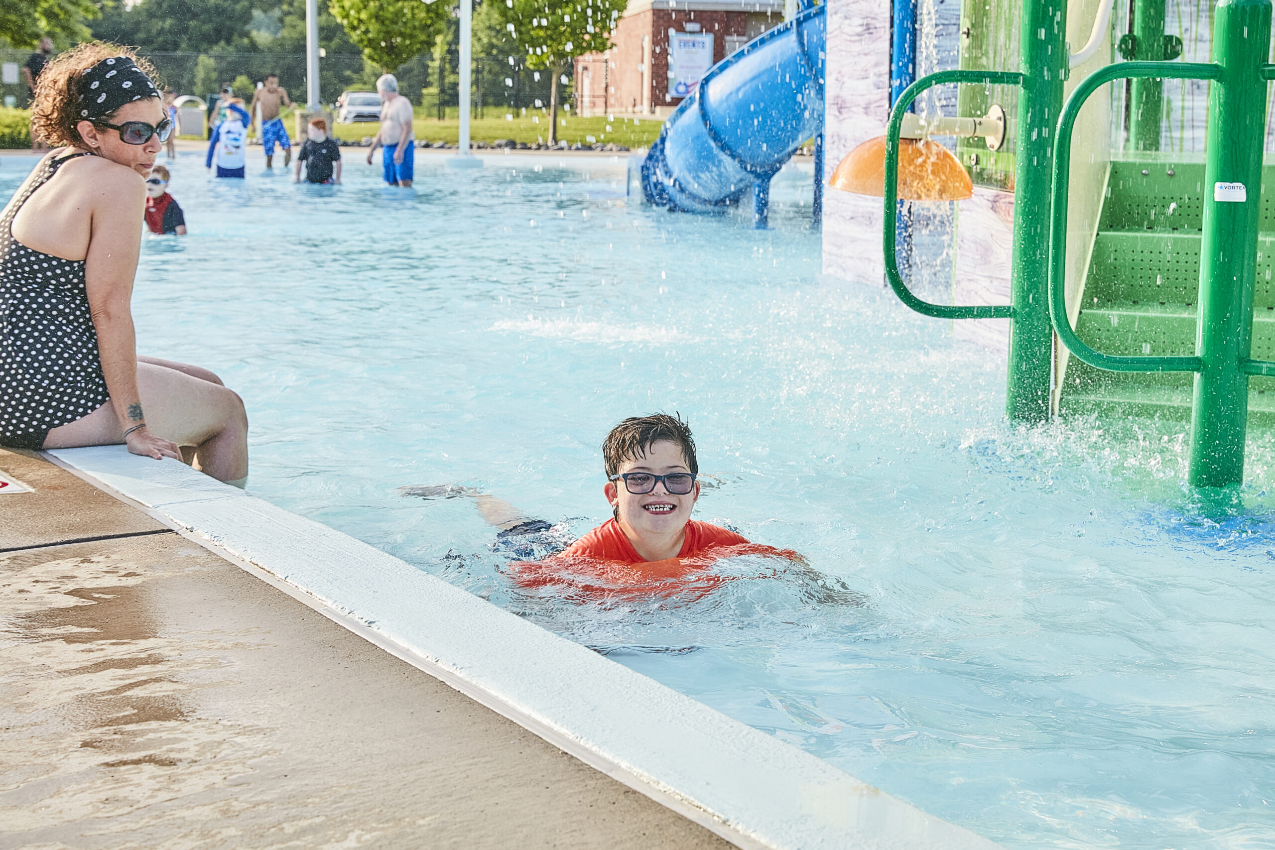 Child swims along the side of the activity pool at The Waterpark.