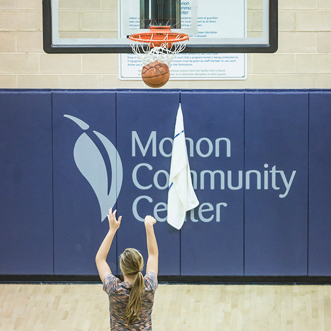 Man shooting a basketball in the gym at Monon Community Center in Carmel