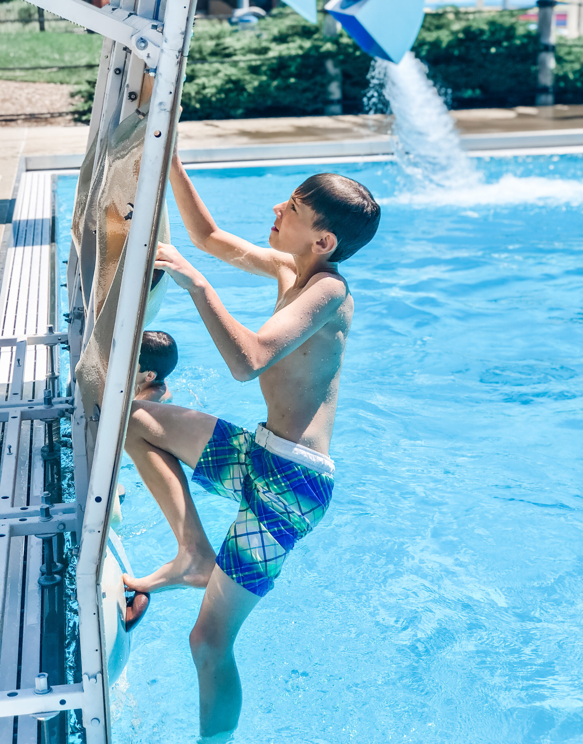 kiddo scales the wall in the dive well at The Waterpark