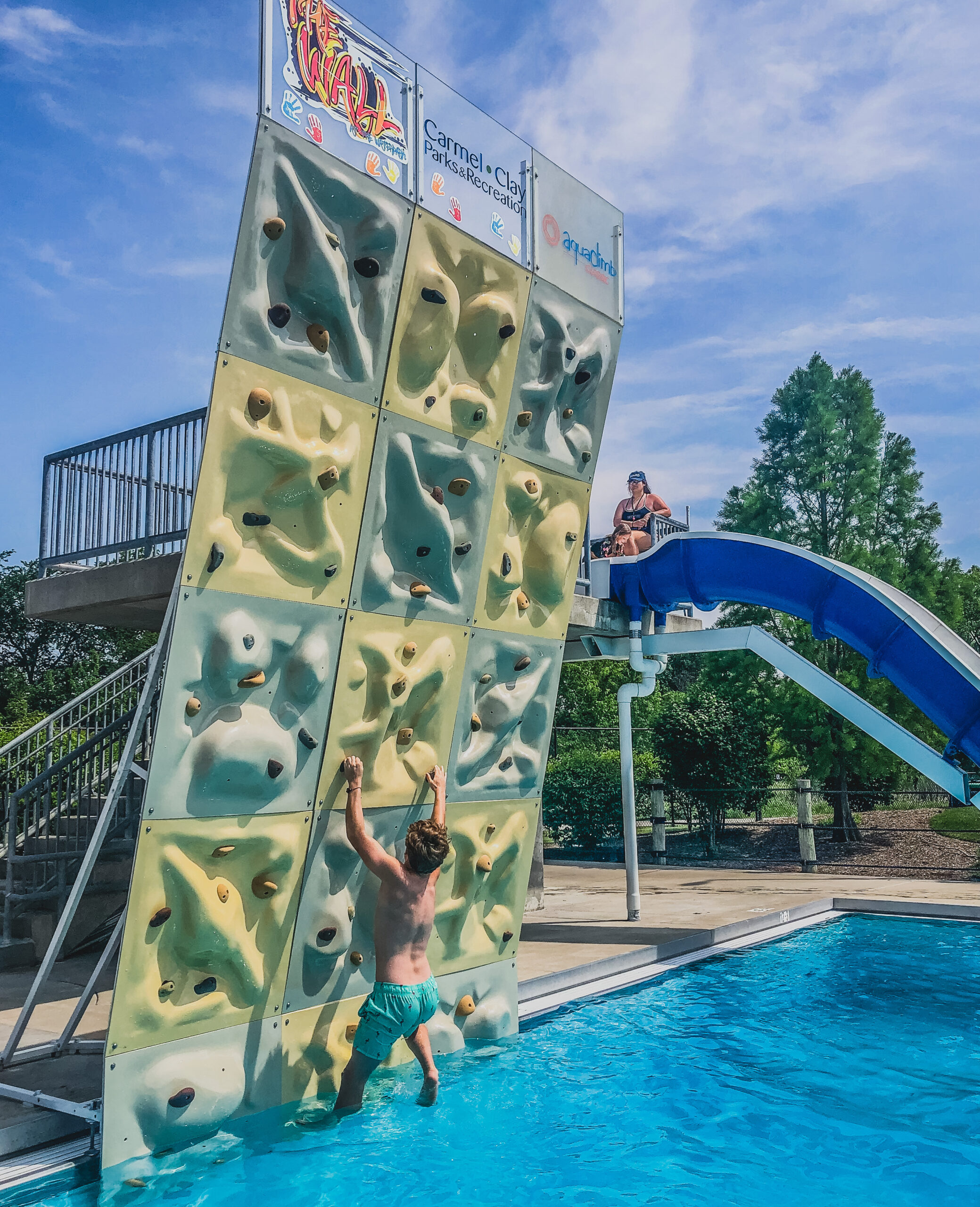 kiddo scales the wall in the dive well at The Waterpark