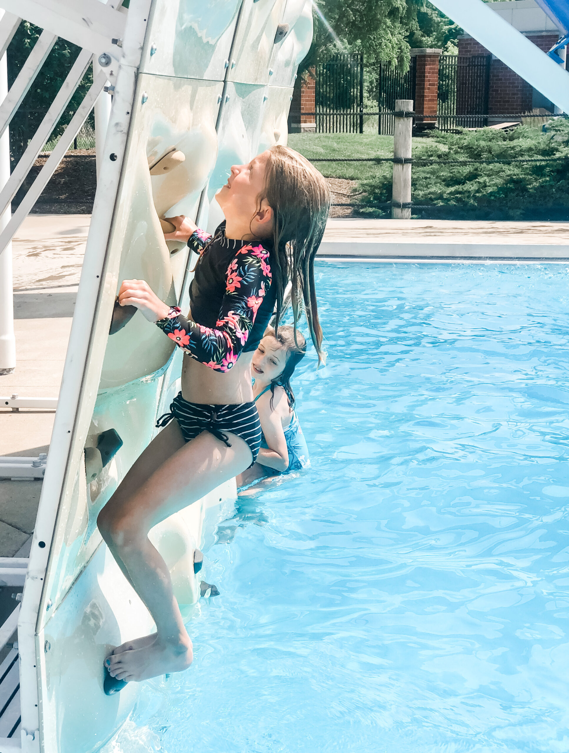 kiddo scales the wall in the dive well at The Waterpark