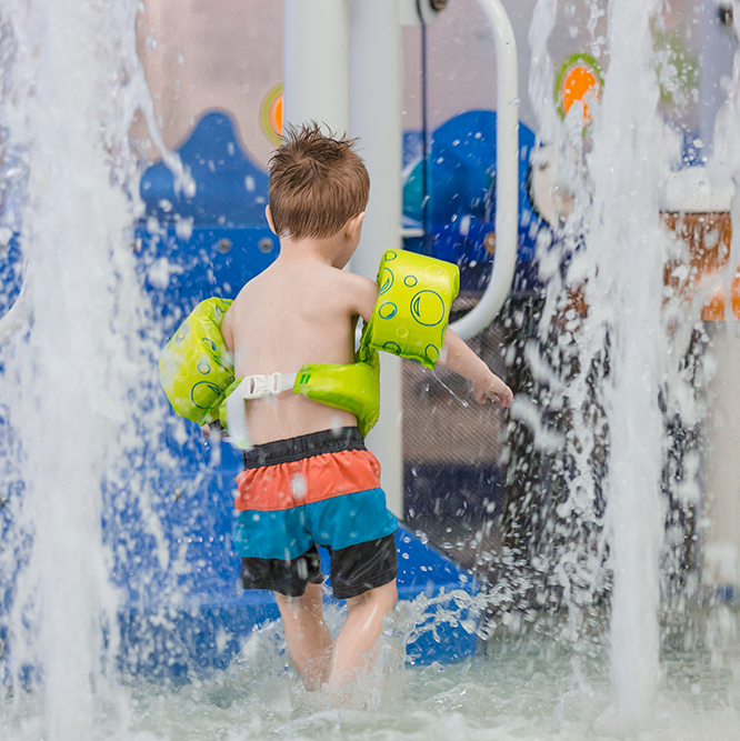 Kid playing at Monon Community Center pool