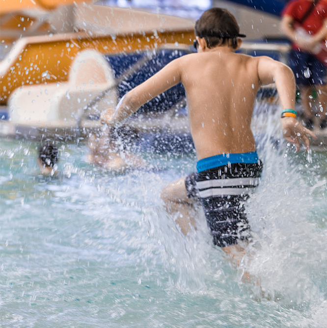 Kid playing at Monon Community Center pool