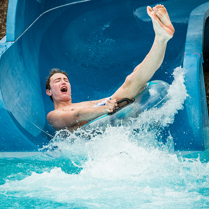 Boy on the blue water slide at The Waterpark.