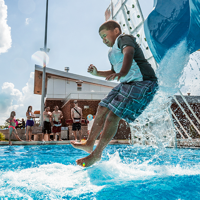 boy on the blue plunge slide