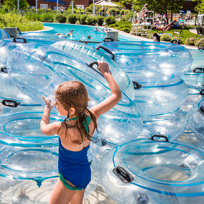 girl grabbing a tube at the Lazy River