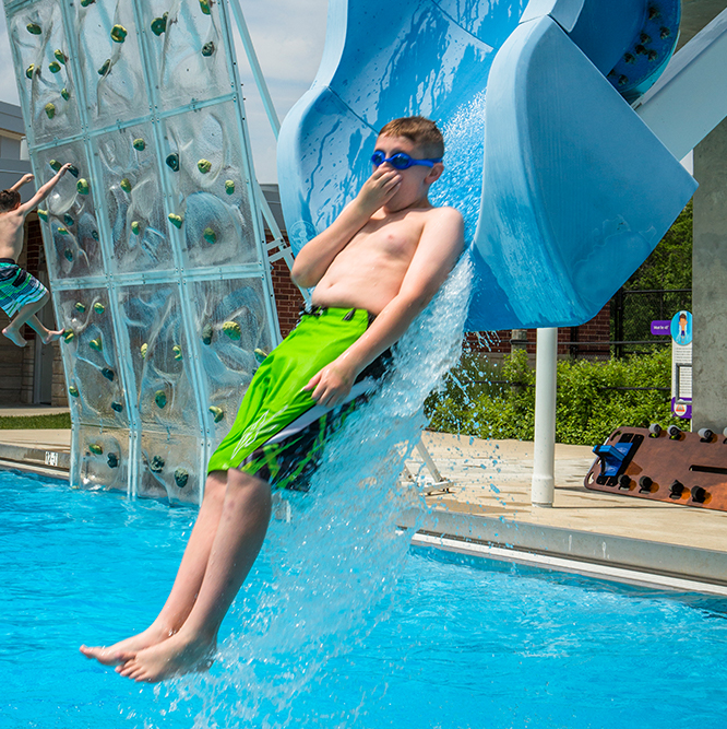 boy on the blue plunge slide