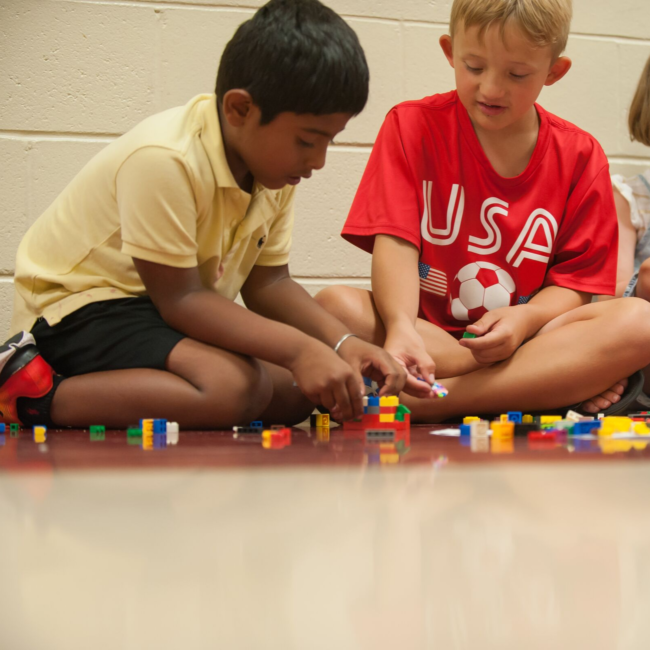 Kids building with legos in an adventures in art summer camp