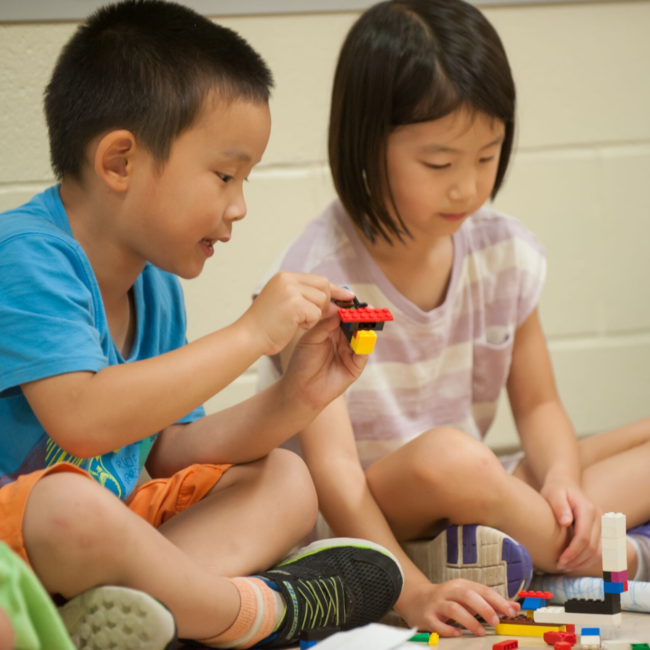 Kids building with legos in an adventures in art summer camp