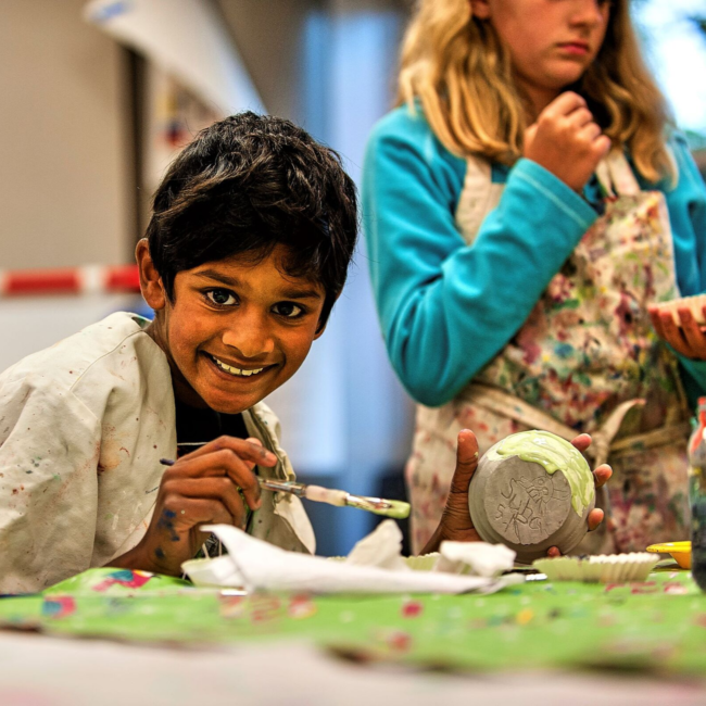 Kids painting in an adventures in art summer camp