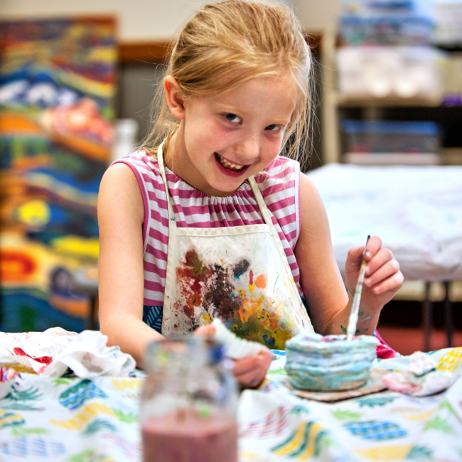 Girl painting in an adventures in art summer camp