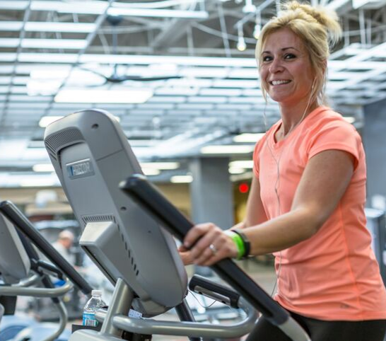 Woman on elliptical in the Fitness Center at the Monon Community Center