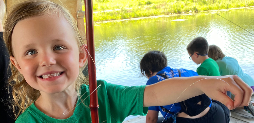 Child holds fish caught in the lagoon.