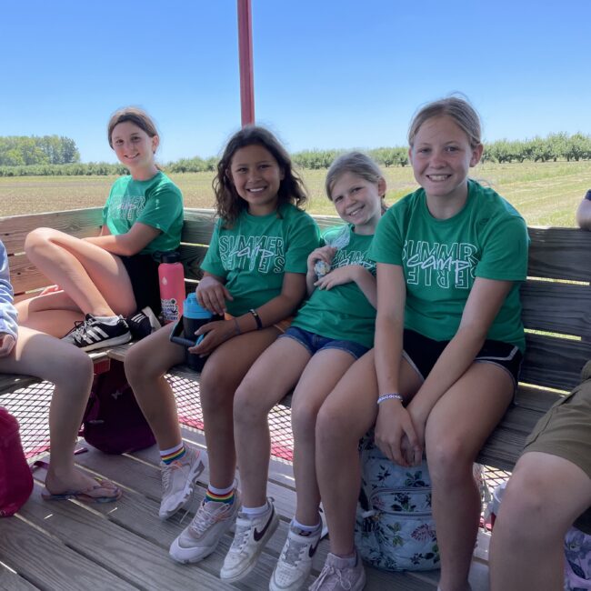 Participants on a tractor ride at orchard.