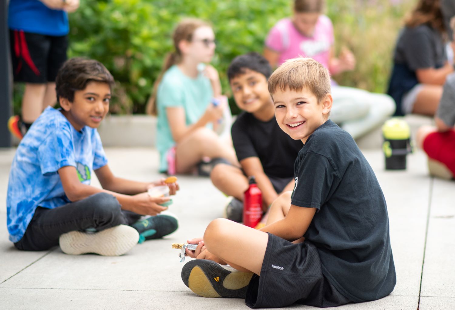 Kids at summer camp enjoying snack.