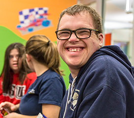 Man smiling in an adaptive program