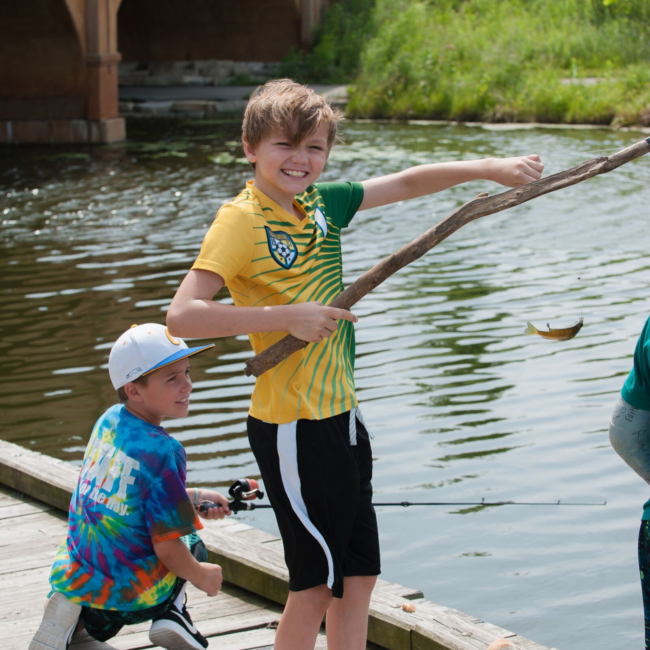 Kids fishing in a great outdoors summer camp