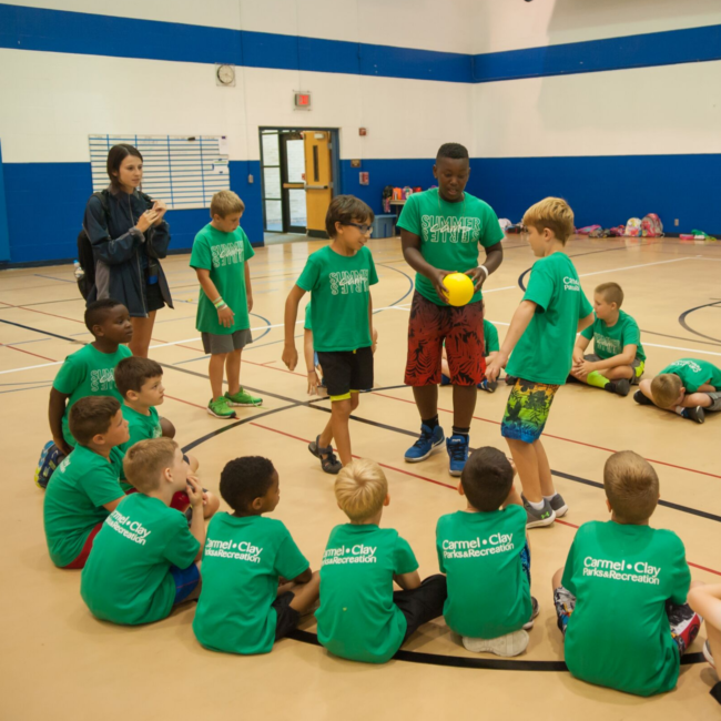 Group sitting in a circle at the summer experience summer camp