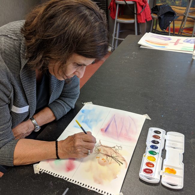 Woman painting in a senior program