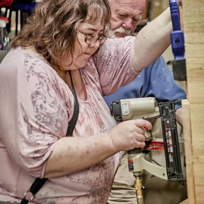 Woman woodworking in a senior program