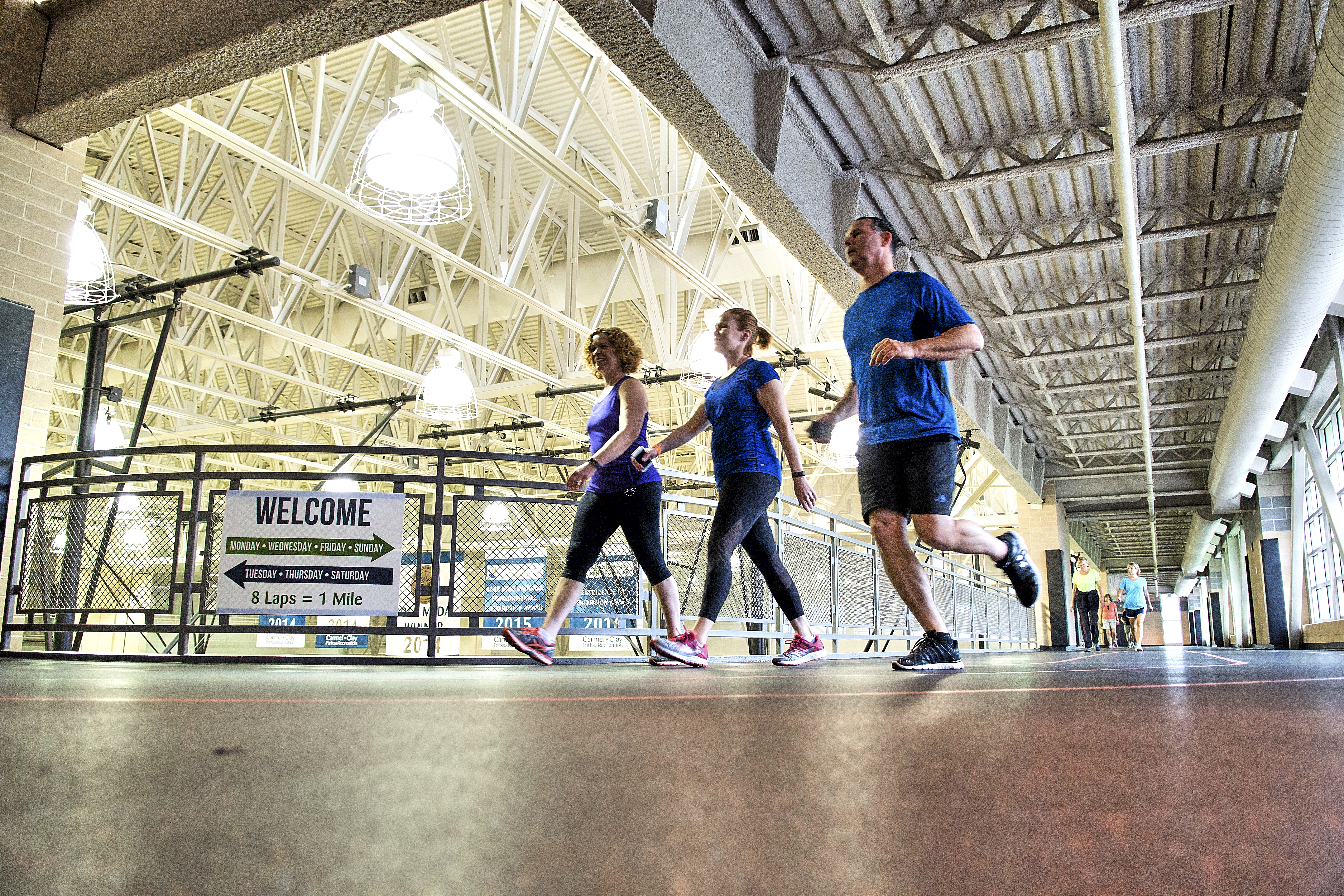 Group running on the indoor track at the gym in Carmel