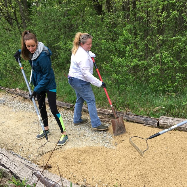 Volunteers shoveling limestone at West Park