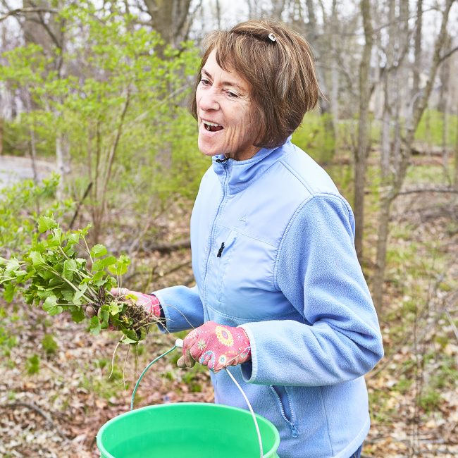 Woman smiling and cleaning our parks