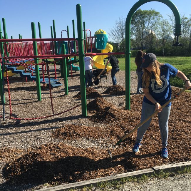 Volunteer mulching at a playground