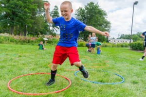 Kid playing outside with hoops