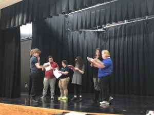 Actors practicing on stage