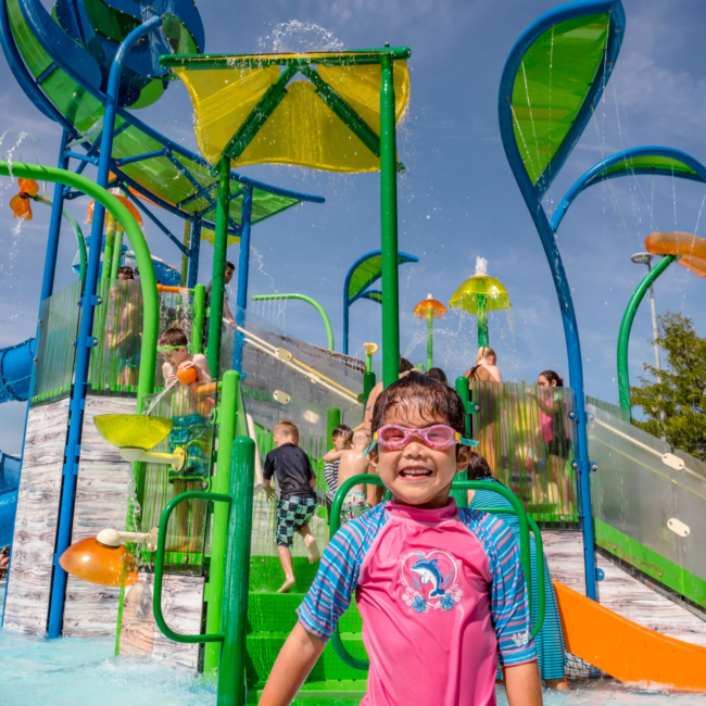 Girl splashing in the outdoor pool at the Waterpark