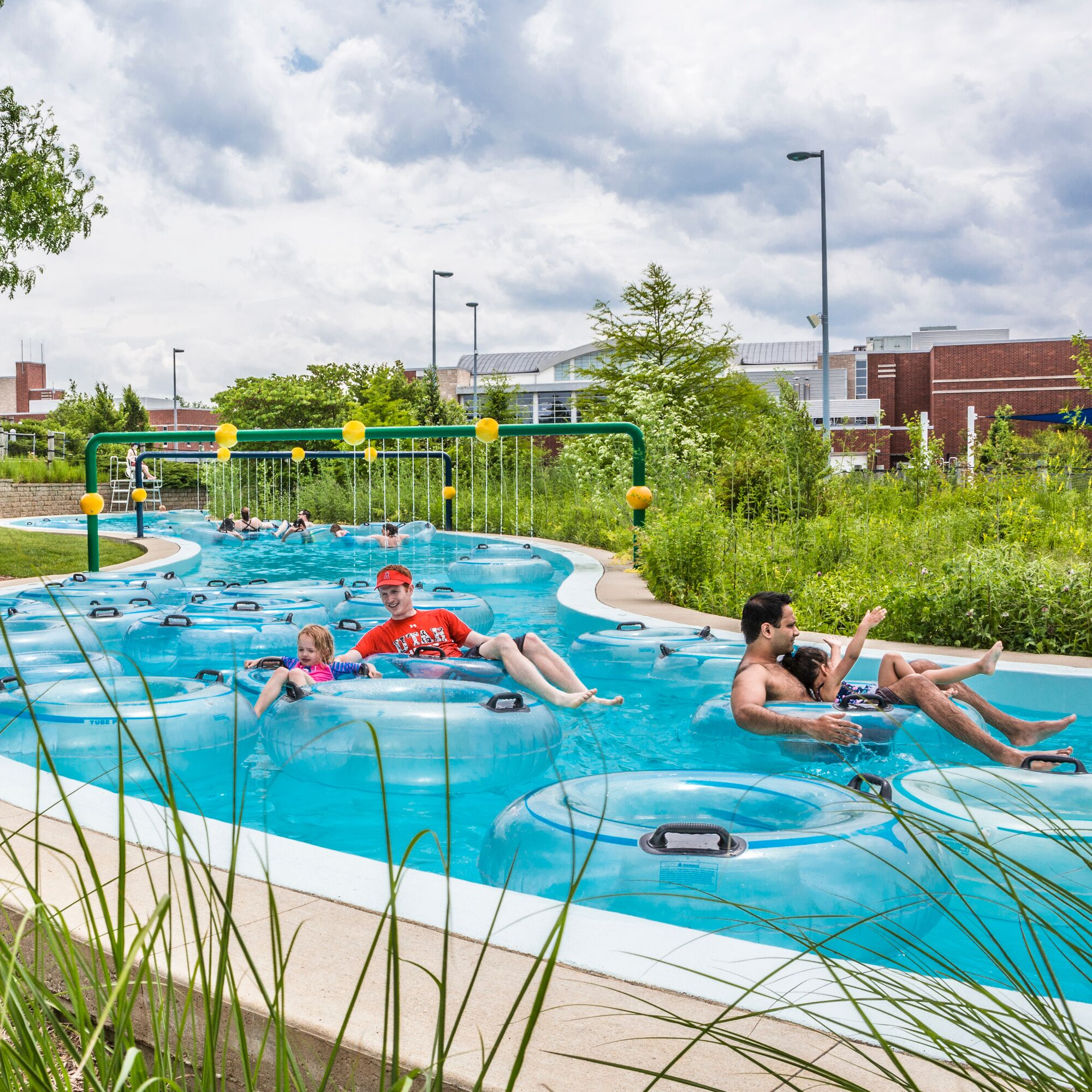 happy people floating in the lazy river in the sun