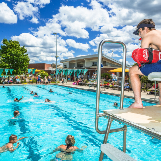 lifeguard instructing people in the outdoor lap pool at The Waterpark