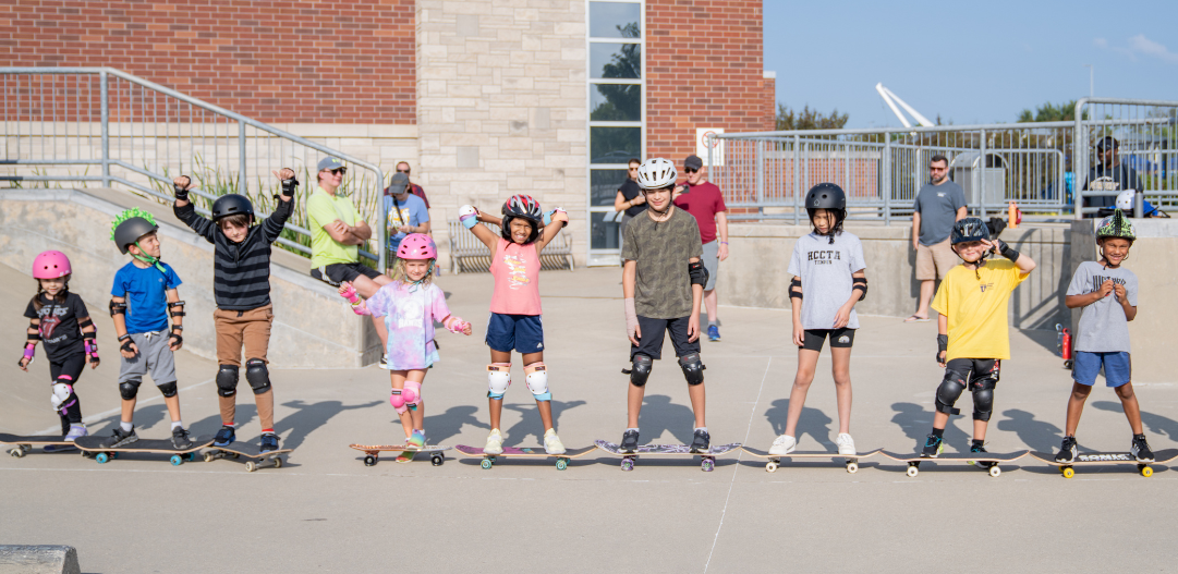 Beginner skateboarding class lines up for a photo at the Skatepark.