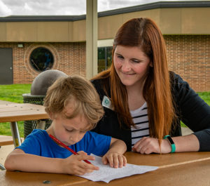 Aimee Riche assists student with homework during ESE