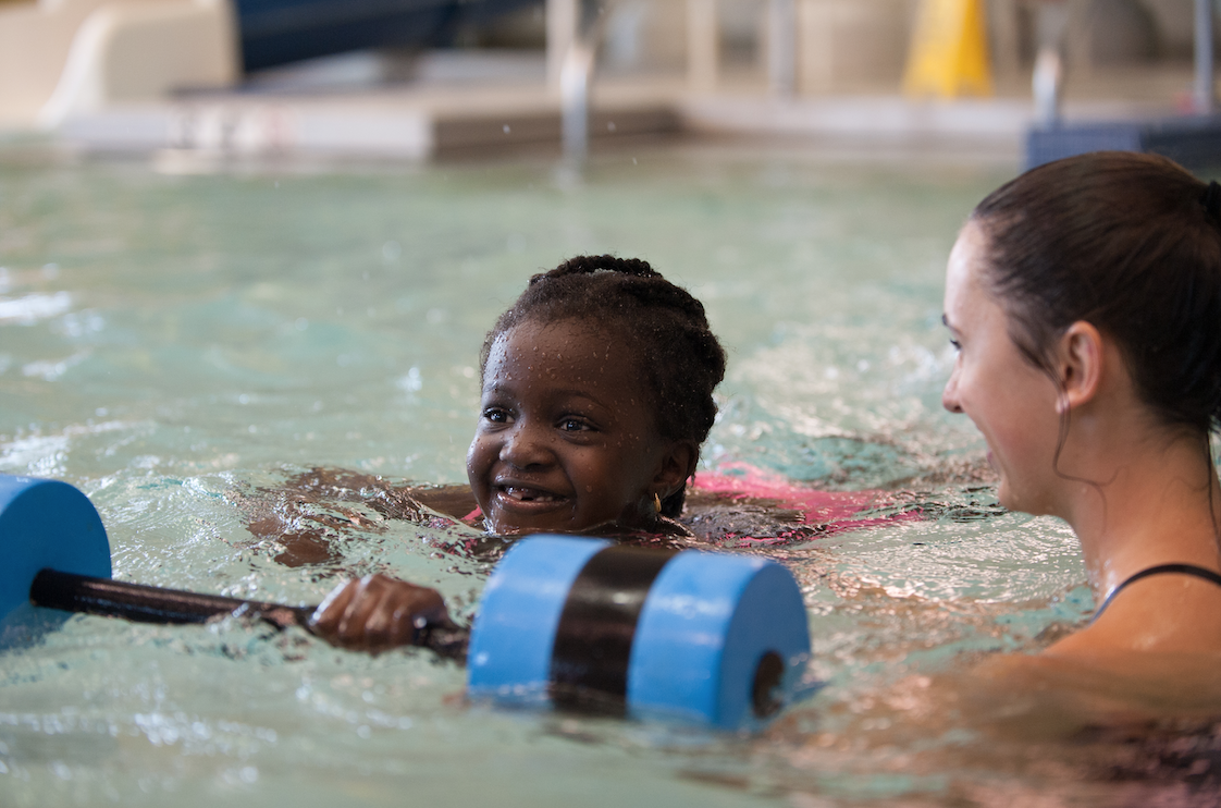 Swim instructor working with participant