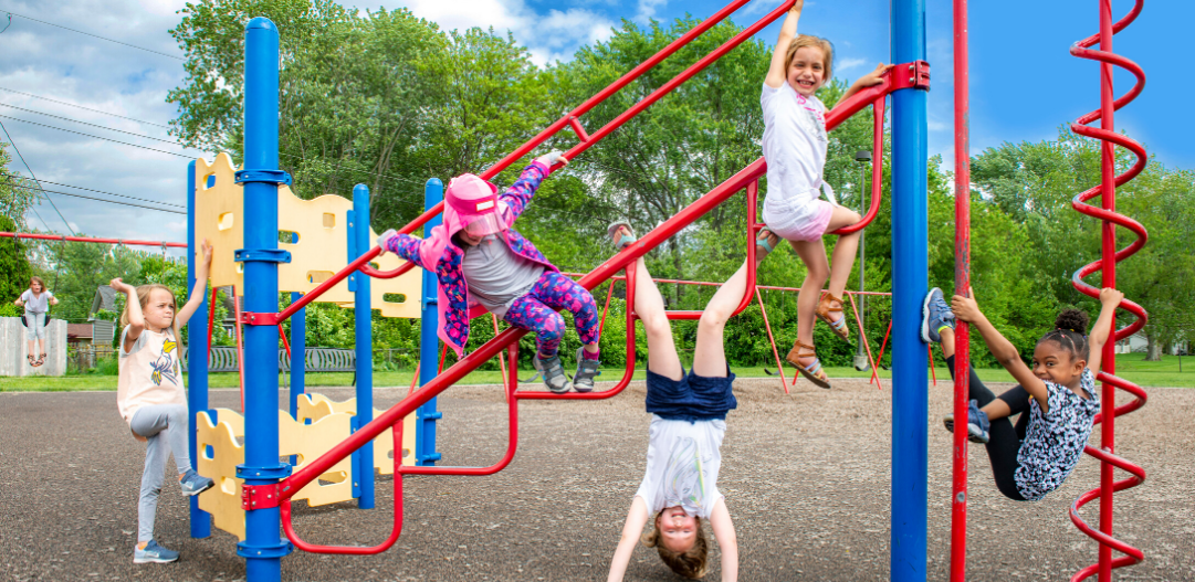 Kids playing on the playground at a summer camp