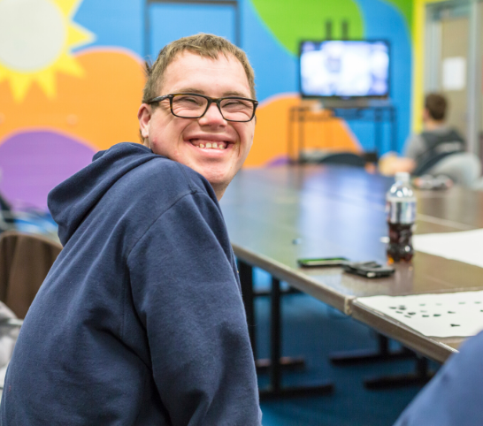 Boy smiling in an adaptive program