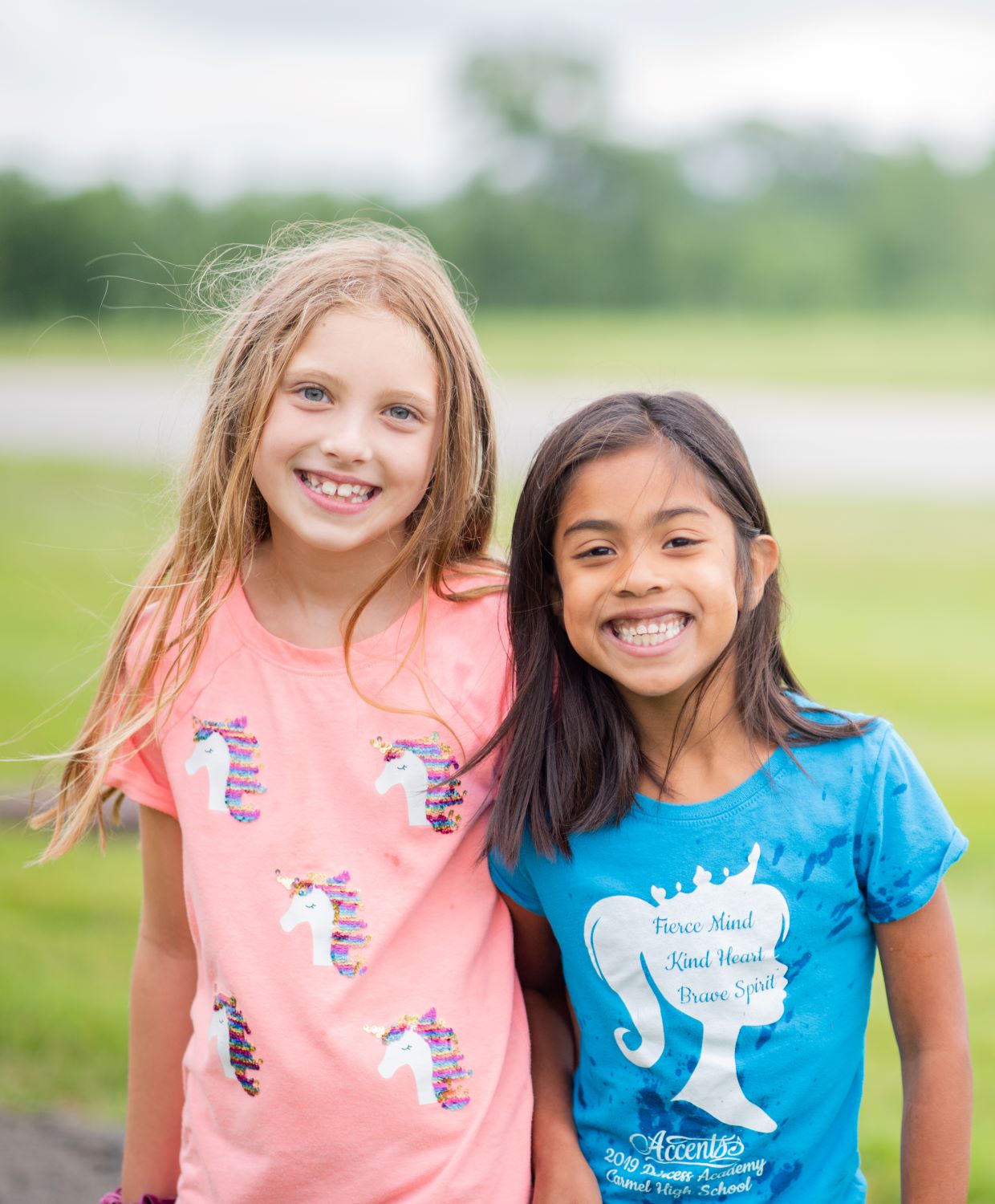 Children in a summer camp smile for the camera while out for a nature walk at West park.