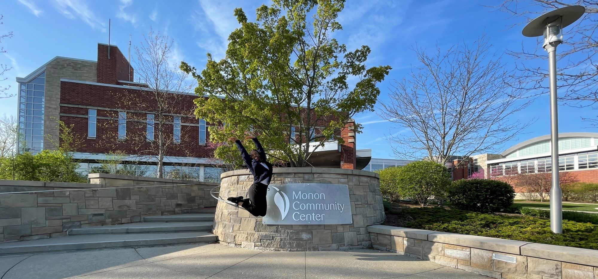 Breanna jumping in front of the Monon Community Center