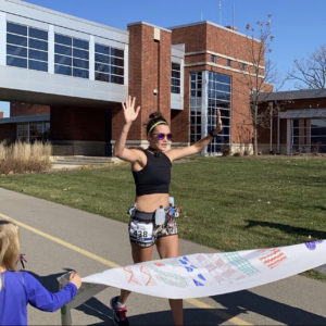 Amanda Luper crosses the finish line for her virtual half marathon