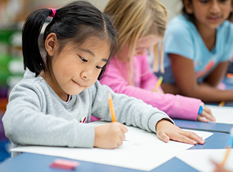 Child works on homework during ESE after school program.