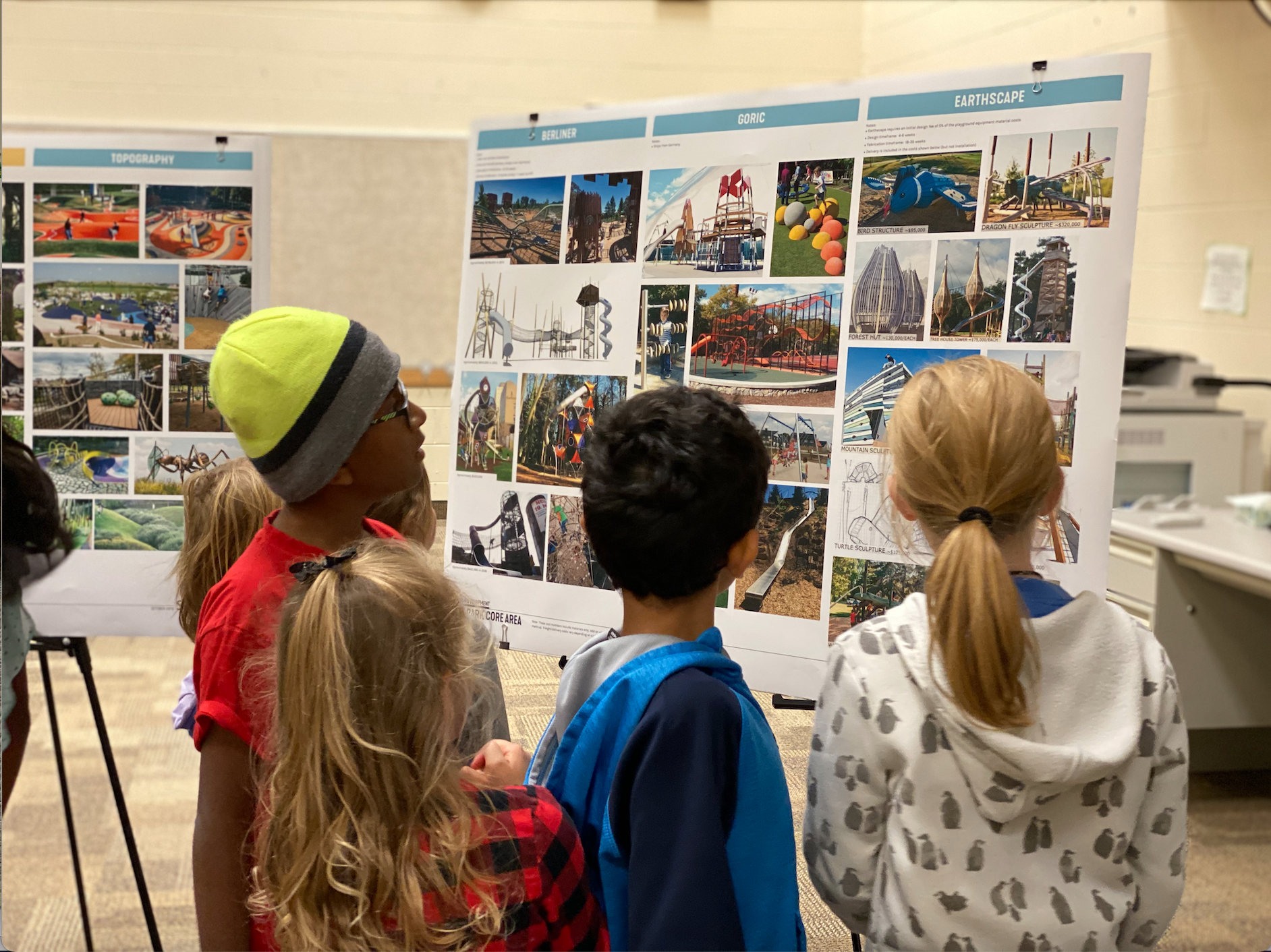 Students look on at how park plans and concepts are brought to life on concept boards.