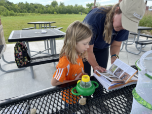 Joanna Scott works with Pollinator BioBlitz participant to identify an insect.