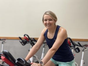Janine Beazley sits on a spin cycle bike in the MCC cycle studio.