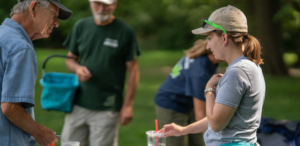 Volunteer coordinator Caitlin May works with volunteers at a Summer Foray mushroom and fungi identification event.