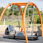 Adaptive and inclusive swing that is wheelchair friendly with a large platform at River Heritage Park's newly reimagined playground.