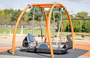 Adaptive and inclusive swing that is wheelchair friendly with a large platform at River Heritage Park's newly reimagined playground.