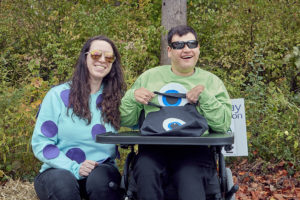 Participants dressed and Mike and Sulley from Monsters Inc pose for a photo at the Sensory Friendly Trick or Treat walk.